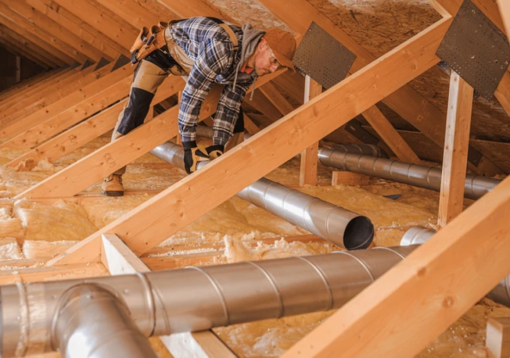 HVAC duct work being installed in an attic